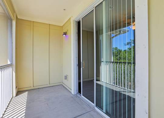 Model balcony with sliding glass door.