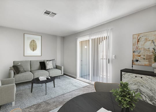 Model Living Room and Dining Room Area with Carpet at Loma Vista Apartments in Las Vegas, NV.