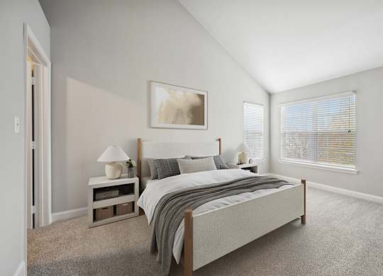 Model Bedroom with Carpet and Walk in Closet at Dulles Green Apartments located in Herndon, VA.