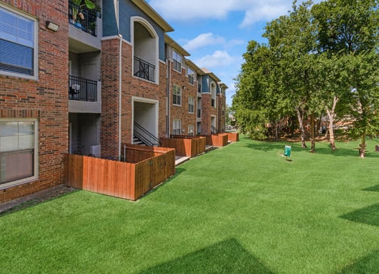 Exterior Community Building and Landscape at Belmont at Duck Creek Apartments in Garland, TX.