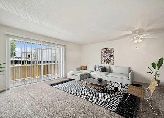 Model Classic Living Room with Carpet and Patio Accessibility at Butler Ridge Apartments located in Glendale, AZ.