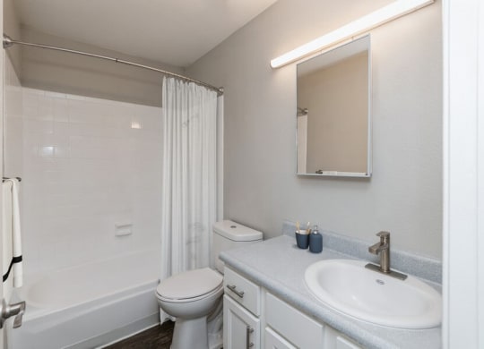 Model Bathroom with Wood-Style Flooring at Indigo Park Apartments in Albuquerque, NM.