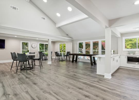 Community Clubhouse with Island Bar and Lounge Furniture and Game Tables at Dunwoody Village Apartments in Atlanta, GA.