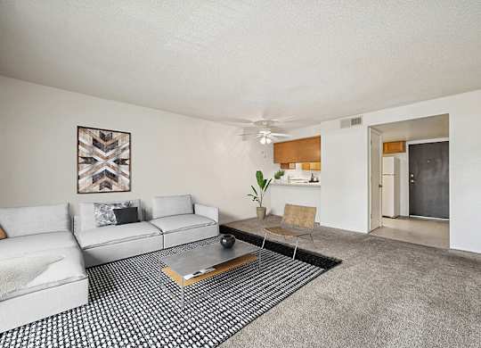 Model Classic Living Room with Carpet and Patio Accessibility at Butler Ridge Apartments located in Glendale, AZ.