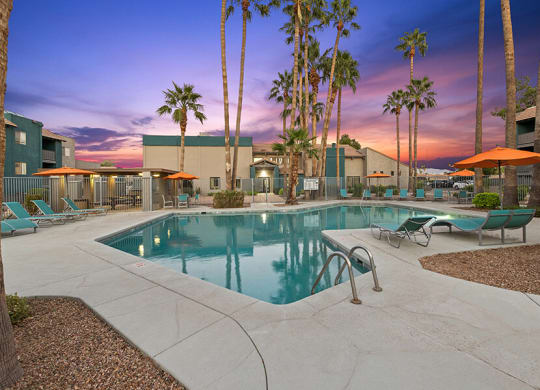 Community Swimming Pool with Pool Furniture at Tanque Verde Apartments located in Tucson, AZ.