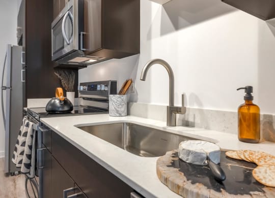 Model kitchen with undermount sink and a microwave