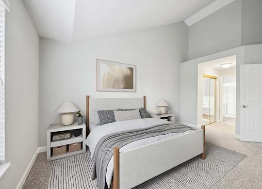 Model Bedroom with Carpet and attached Bathroom at Dulles Green Apartments located in Herndon, VA.