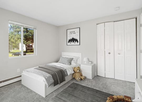 Model second bedroom with plush carpeting