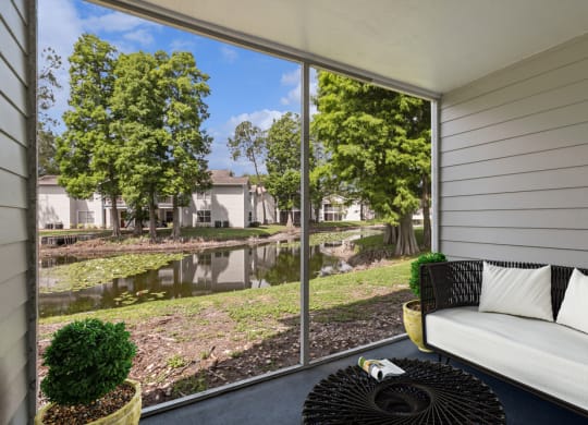 Patio with a couch and a cof fee table at Retreat at Crosstown Apartments