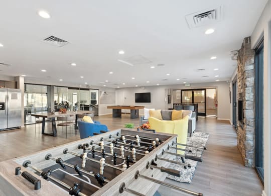 Community Clubhouse with Lounge Furniture and Pool Table Area at Liberty Creek Apartments in Aurora, CO.