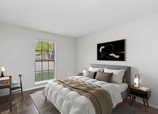 Model Bedroom with Wood-Style Flooring and Window View at Grand Pavilion Apartments in Tampa, FL.
