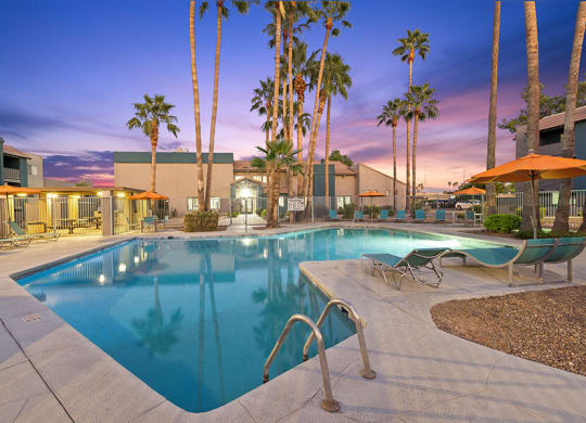 Community Swimming Pool with Pool Furniture at Tanque Verde Apartments located in Tucson, AZ.