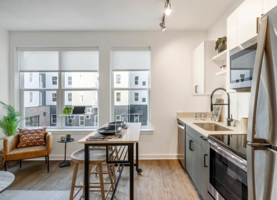 Model open kitchen and dining area with a large window