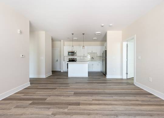 A kitchen with a white island in the middle of the room.