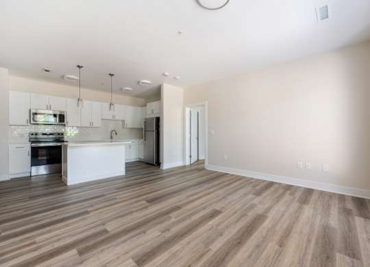 A spacious kitchen with a dining area and a living room.
