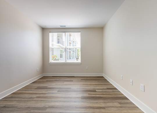 A room with wooden floors and a window.