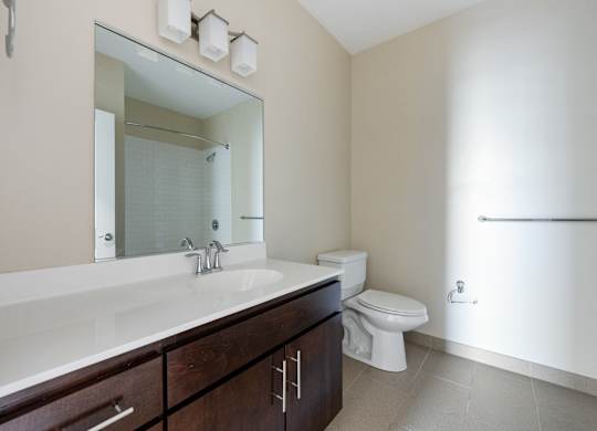 A bathroom with a white sink and a toilet.