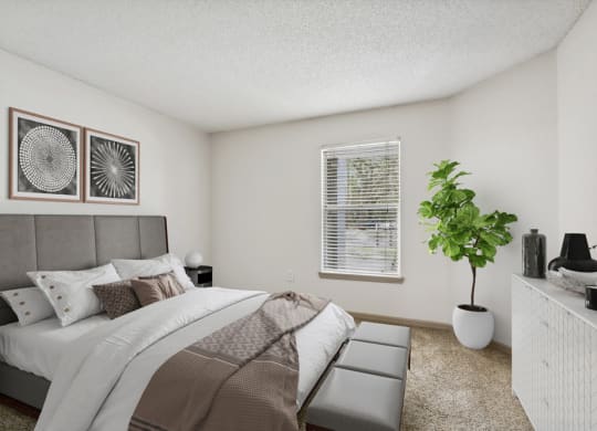 Model bedroom with a large bed at Retreat at Crosstown Apartments