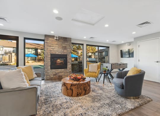Community Clubhouse with Lounge Furniture and a Fireplace at Liberty Creek Apartments in Aurora, CO.
