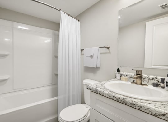 Model bathroom with a sink toilet and shower