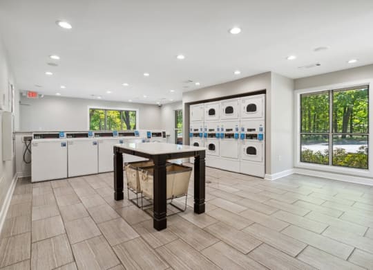 Community Laundry Center with Washing Machines and Dryers at Dunwoody Village Apartments in Atlanta, GA.