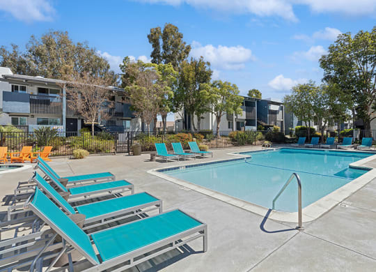 Community Swimming Pool with Pool Furniture at Colonnade at Fletcher Hills Apartments in El Cajon, CA.