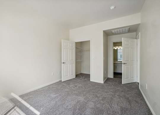 Model Bedroom with Carpet and Walk-In Closet at Altitude on Fifth Apartments located in Salt Lake City, UT.