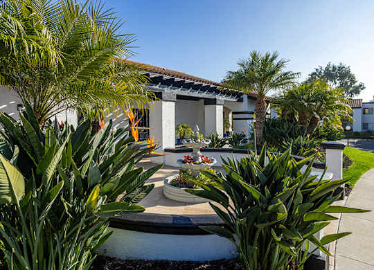 Exterior Community Building with Fountain and Landscape at Santa Fe Ranch Apartments located in Carlsbad, CA.