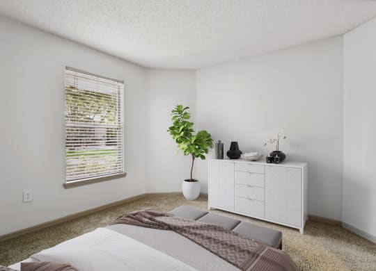 Model bedroom with carpeting at Retreat at Crosstown Apartments