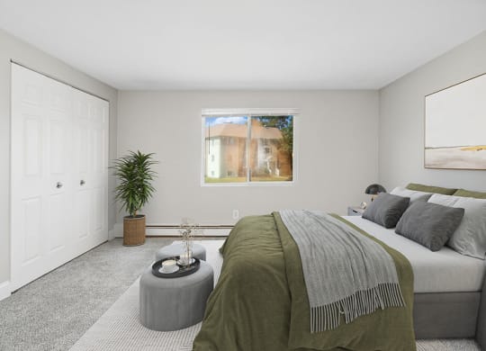 Model bedroom with queen bed and a window