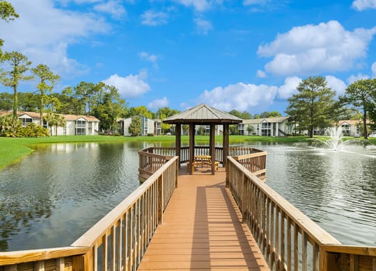 Gazebo at the end of a wooden dock overlooking a pond with a fountain at Vue at Baymeadows Apartments in Jacksonville, Florida