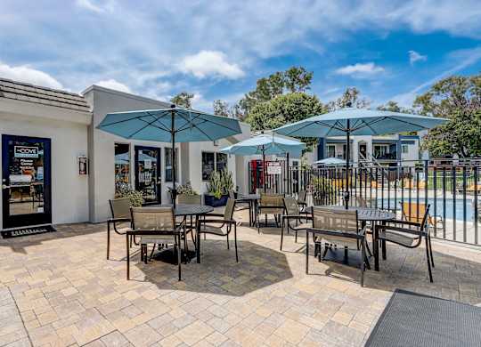 Community Picnic Tables with Umbrellas at Cove La Mesa Apartments located in La Mesa, CA.