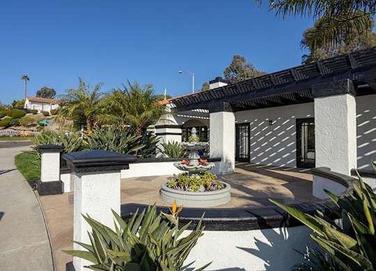 Exterior Community Building with Fountain and Landscape at Santa Fe Ranch Apartments located in Carlsbad, CA.