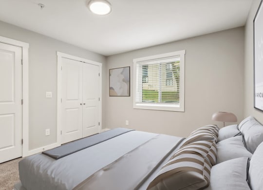 Model bedroom with a bed and a window