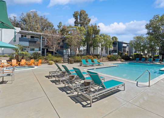 Community Swimming Pool with Pool Furniture at Colonnade at Fletcher Hills Apartments in El Cajon, CA.