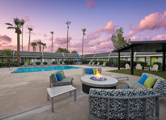 Outdoor Fire Pit Area and Swimming Pool with Lounge Furniture at Arcadia on 49th Apartments located in Phoenix, AZ.