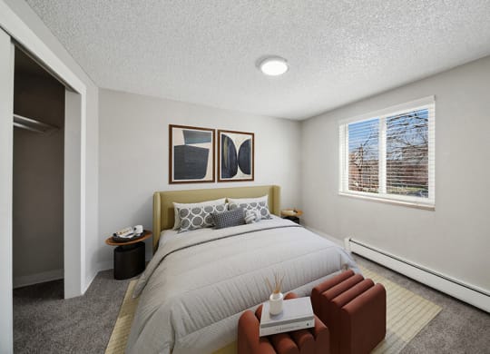 Model Bedroom with Carpet and Closet at Esprit at Cherry Creek Apartments in Glendale, CO.