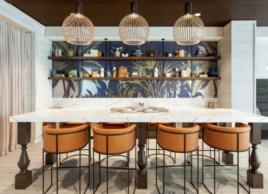 a kitchen with a marble counter top and chairs