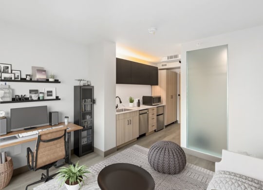 Model living and kitchen areas with office desk