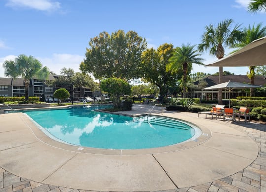 Community Swimming Pool with Pool Furniture at Fountains Lee Vista Apartments in Orlando, FL.