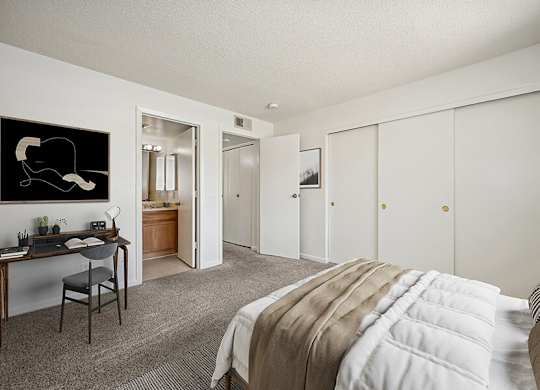 Model Bedroom with Carpet and attached Bathroom at Butler Ridge Apartments located in Glendale, AZ.