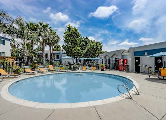 Community Swimming Pool with Pool Furniture at Cove La Mesa Apartments located in La Mesa, CA.