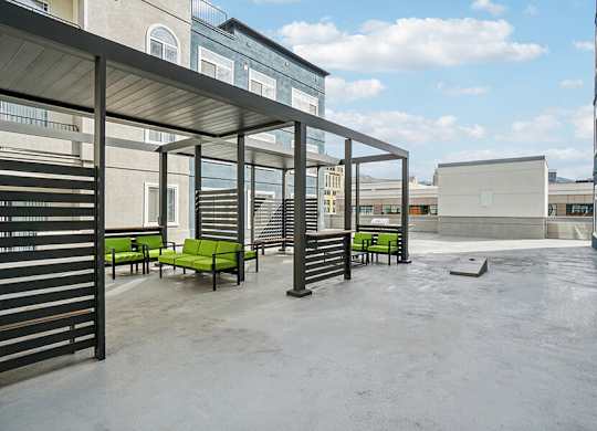Rooftop Patio with Lounge Furniture and Cornhole at Altitude on Fifth Apartments located in Salt Lake City, UT.
