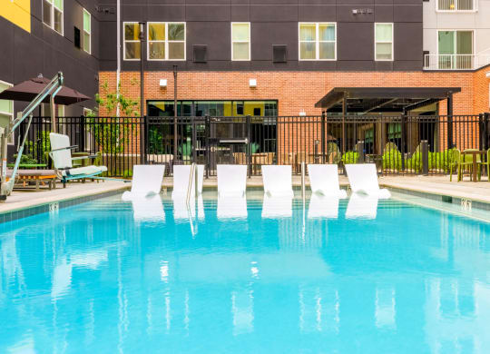 Swimming pool with in-pool loungers