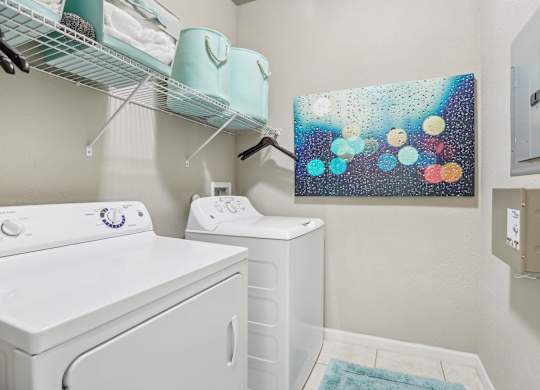 Model laundry room with a washer and dryer.