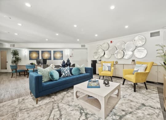 a living room with couches and chairs and a table