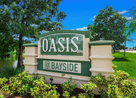Property sign at Oasis at Bayside Apartments in Largo, FL