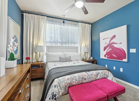 Model bedroom with blue accent wall.