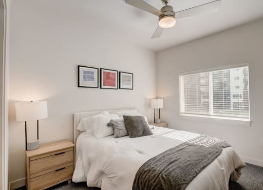 a bedroom with a large bed and a ceiling fan