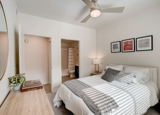 a bedroom with a large bed and a ceiling fan